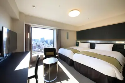a hotel room with two beds and a large window at Richmond Hotel Premier Asakusa International in Tokyo