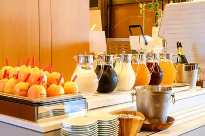 a buffet with drinks and oranges on a counter at Richmond Hotel Premier Asakusa International in Tokyo