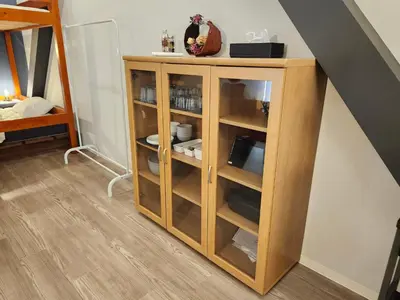 a wooden cabinet in a room with a staircase at Ark Hills Haneda Inn in Tokyo