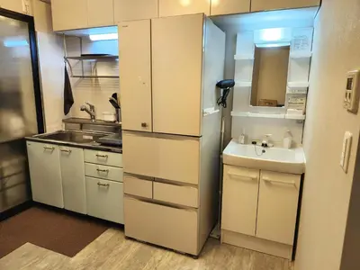 a small kitchen with a sink and a refrigerator at Ark Hills Haneda Inn in Tokyo