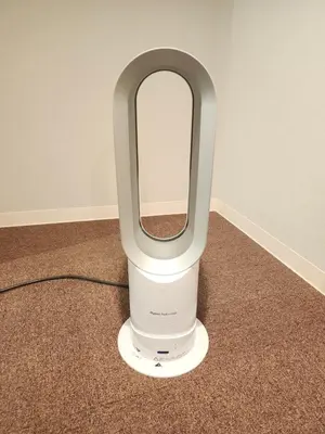 a white hair dryer sitting on a carpet at Ark Hills Haneda Inn in Tokyo