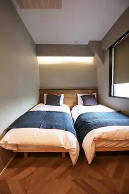 two beds sitting next to each other in a room at the Moto Hotel Ueno II in Tokyo