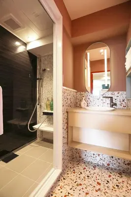 a bathroom with a shower and a sink and a mirror at the Moto Hotel Ueno II in Tokyo