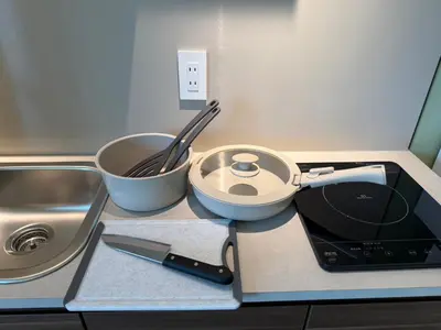 a kitchen counter with a counter top with a sink and a pot at the Moto Hotel Ueno II in Tokyo