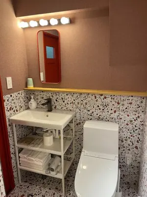 a bathroom with a sink and a toilet and a mirror at the Moto Hotel Ueno II in Tokyo