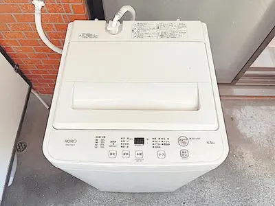 a white washing machine sitting outside of a building at Tokyo Stay West Sugamo #103 in Tokyo