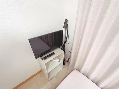 a flat screen tv sitting on a stand in a room at Tokyo Stay West Sugamo #103 in Tokyo