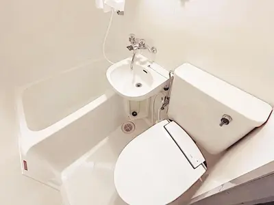 a white bathroom with a toilet and a sink at Tokyo Stay West Sugamo #103 in Tokyo