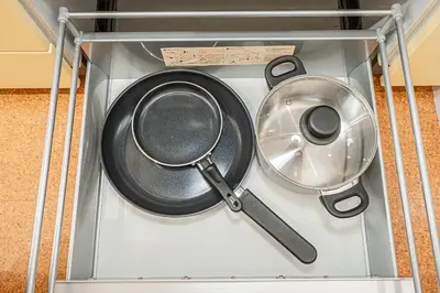 a set of pans in a glass display case at phoneix apt ginza in Tokyo