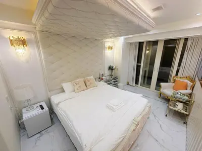 a bedroom with a large white bed and a chair at ReimiMondo 6702 in Tokyo