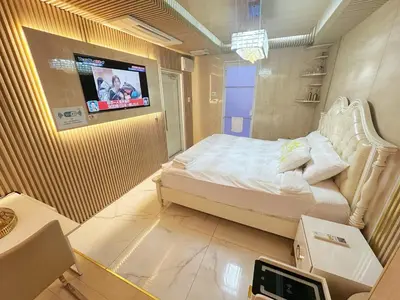 a bedroom with a bed and a tv on a wall at ReimiMondo 6702 in Tokyo