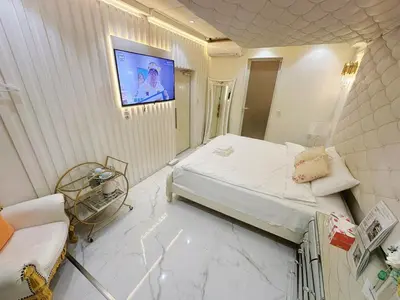 a bedroom with a bed and a tv on the wall at ReimiMondo 6702 in Tokyo