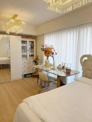 a bedroom with a table with flowers on it at ReimiMondo 1107 in Tokyo
