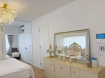 a bedroom with a mirror on top of a dresser at ReimiMondo 1107 in Tokyo