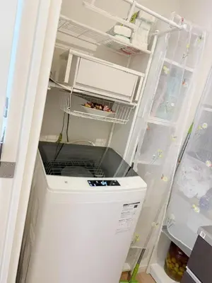 an empty refrigerator with its door open with food inside at ReimiMondo 1107 in Tokyo