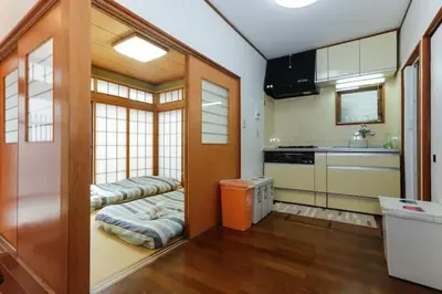 a kitchen with two beds in the middle of a room at \u897f\u65b0\u5bbf\u548c\u5eb5 wa-an homestay in Tokyo