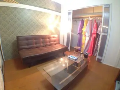 a living room with a couch and a glass table at \u897f\u65b0\u5bbf\u548c\u5eb5 wa-an homestay in Tokyo