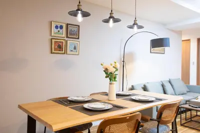a dining room table with a vase of flowers on it at \u96fb\u8eca\u3067\u65b0\u5bbf\u307e\u306710\u52063ldk2\u500b\u30c8\u30a4\u30ec2\u500b\u30b7\u30e3\u30ef\u30fc\u5ba4\u7121\u6599\u99d0\u8eca\u5834\u5ead\u4ed8\u304d in Tokyo