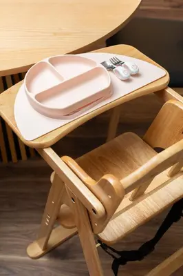 a wooden chair with a plate on a table at Kotori Ikebukuro in Tokyo