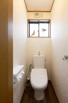 a bathroom with a white toilet and a window at Kotori Ikebukuro in Tokyo