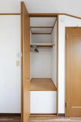 a closet with a wooden door in a room at Kotori Ikebukuro in Tokyo