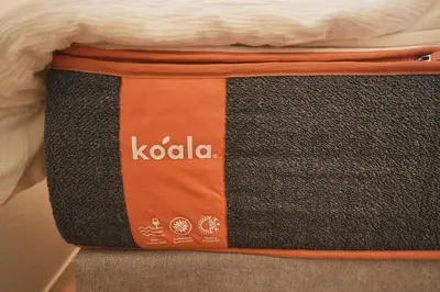 an orange and black suitcase sitting on top of a bed at Tomo House Yotsuya-Sanchome 101 - from 6 minutes station \u56db\u8c37\u4e09\u4e01\u76ee 101 \u99c5\u304b\u3089\u5f92\u6b696\u5206 in Tokyo