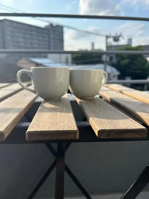 two coffee cups sitting on top of a wooden table at Fuji Hotel Tokyo Takadanobaba2 in Tokyo