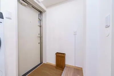 an empty room with a door and a wooden floor at feel Shinjuku STAY in Tokyo