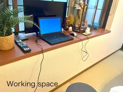 a laptop computer sitting on top of a desk at Senjushuku FUJI 101 \u5317\u5343\u4f4f in Tokyo