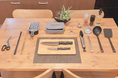 a wooden table with a cutting board and utensils on it at Senjushuku FUJI 101 \u5317\u5343\u4f4f in Tokyo
