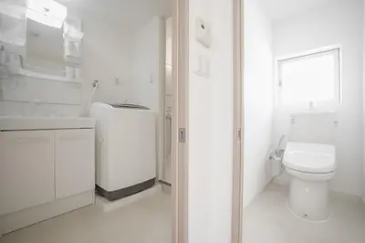 a white bathroom with a toilet and a sink at 3 minutes to Shinjuku by subway-Nakanokaikan II in Tokyo