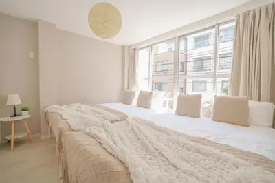 a bedroom with a large bed with a large window at 3 minutes to Shinjuku by subway-Nakanokaikan II in Tokyo