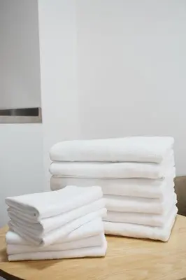 a stack of white towels on a table at 3 minutes to Shinjuku by subway-Nakanokaikan II in Tokyo