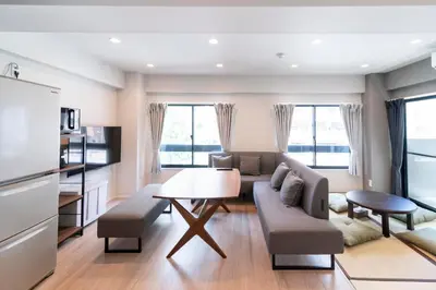 a living room with a couch and a table at VOERE亀戸 - Kameido Modern Suite - Direct to Akihabara & Shinjuku - Near Asakusa, Skytree in Tokyo