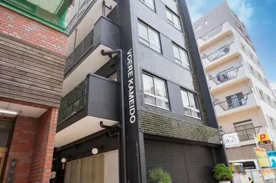 a building with a sign on the side of it at VOERE亀戸 - Kameido Modern Suite - Direct to Akihabara & Shinjuku - Near Asakusa, Skytree in Tokyo