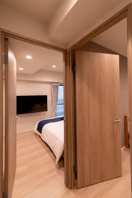 a bedroom with a bed and a sliding glass door at VOERE亀戸 - Kameido Modern Suite - Direct to Akihabara & Shinjuku - Near Asakusa, Skytree in Tokyo