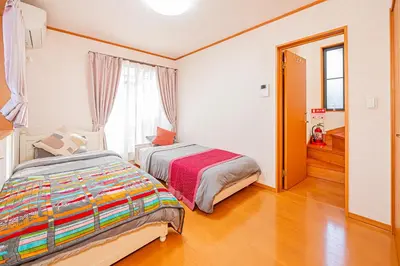 a bedroom with a bed and a large window at Higashi koiwa 4 Bed rooms Villa 5 minutes walk from JR Koiwa station 60min friom Haneda airport in Tokyo