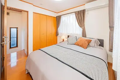 a bedroom with a large bed and a window at Higashi koiwa 4 Bed rooms Villa 5 minutes walk from JR Koiwa station 60min friom Haneda airport in Tokyo