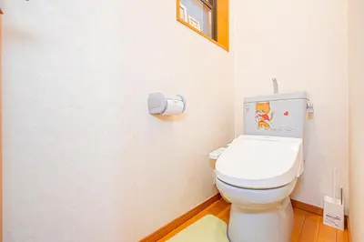 a bathroom with a toilet with a picture on the wall at Higashi koiwa 4 Bed rooms Villa 5 minutes walk from JR Koiwa station 60min friom Haneda airport in Tokyo