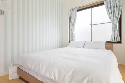 a white bed in a room with a window at Witch's House Walk to Ikebukuro Tokyo's Ghibli Fairy Tale House in Tokyo