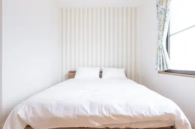 a white bed in a white bedroom with a window at Witch's House Walk to Ikebukuro Tokyo's Ghibli Fairy Tale House in Tokyo