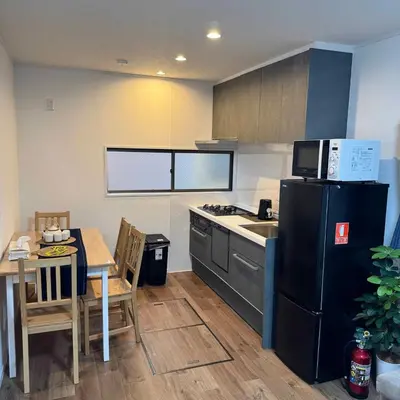a kitchen with a black refrigerator and a table at Entire House 3 Mins Walk from JR station - Family welcome in Tokyo
