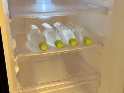 a refrigerator filled with bottles of milk and cheese at Private stay, fully equipped 45 square meter, Easy access to Disneyland & Airports in Tokyo