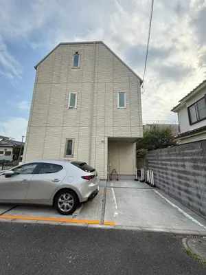 a car parked in a parking lot in front of a building at Private stay, fully equipped 45 square meter, Easy access to Disneyland & Airports in Tokyo