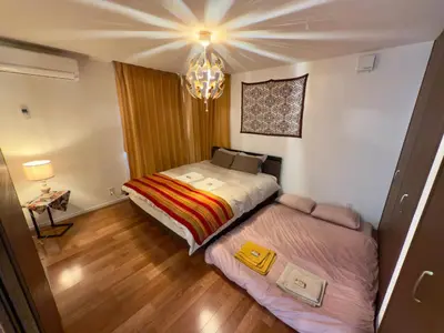 a small bedroom with a bed and a chandelier at Private stay, fully equipped 45 square meter, Easy access to Disneyland & Airports in Tokyo