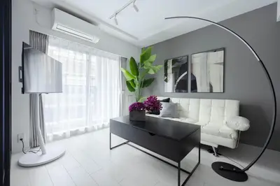 a living room with a white couch and a table at Mocomoco House Azabu in Tokyo