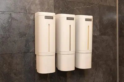 a group of three beige cylinders on a wall at Mocomoco House Azabu in Tokyo