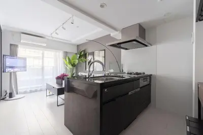 a kitchen with a sink and a stove at Mocomoco House Azabu in Tokyo