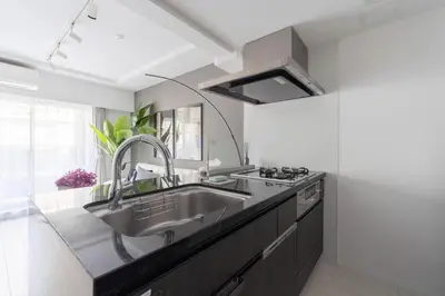 a kitchen with a sink and a large mirror at Mocomoco House Azabu in Tokyo