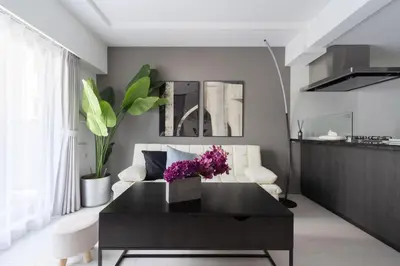 a living room with a black coffee table and a couch at Mocomoco House Azabu in Tokyo
